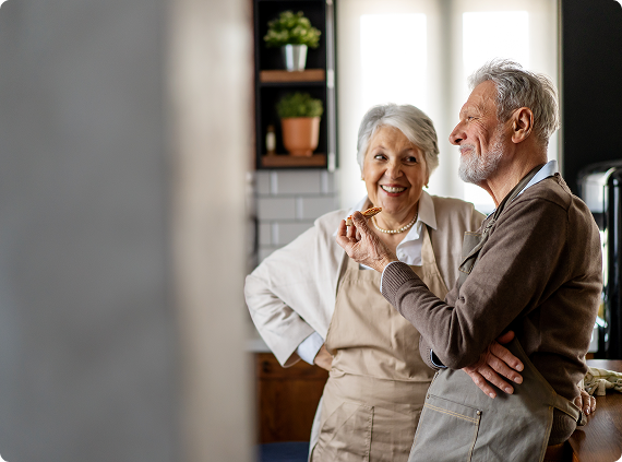 happy-senior-couple-communicating-while-having-fun-kitchen-together